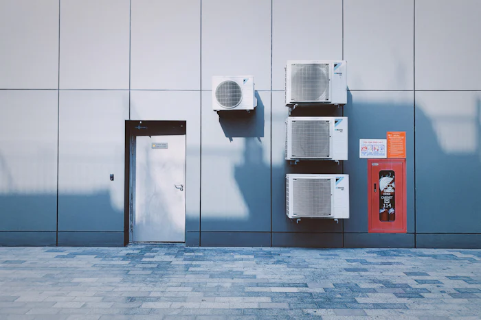 Wall-mounted commercial condensing units outside a building