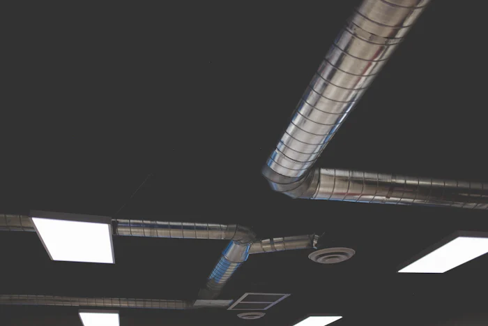 Exposed spiral ductwork in an open office ceiling
