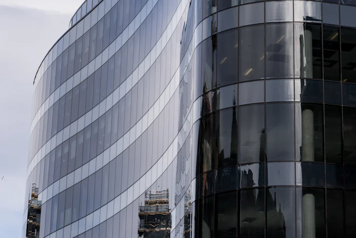 Glass office building against a blue sky